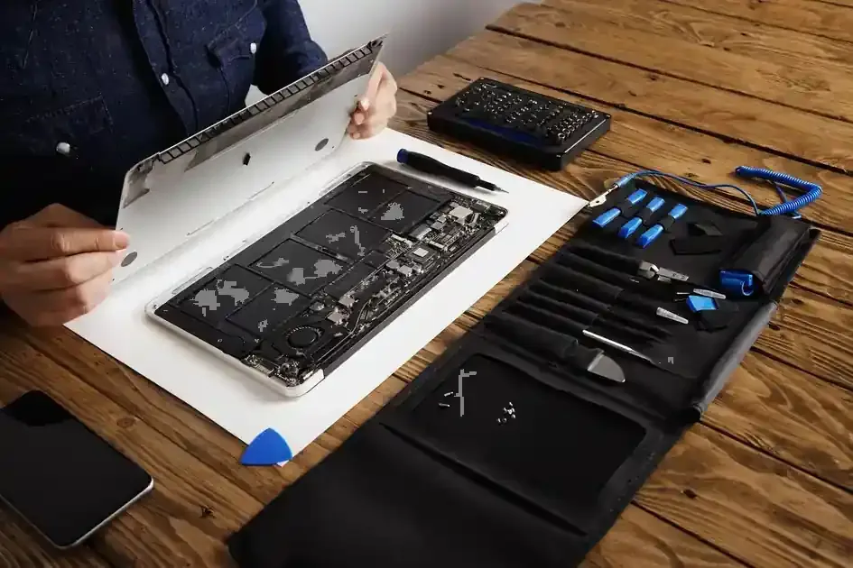 MacBook opened for internal repair with specialist tools